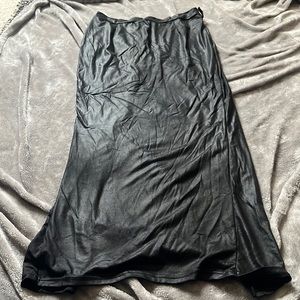 Form fitting black skirt with large slit